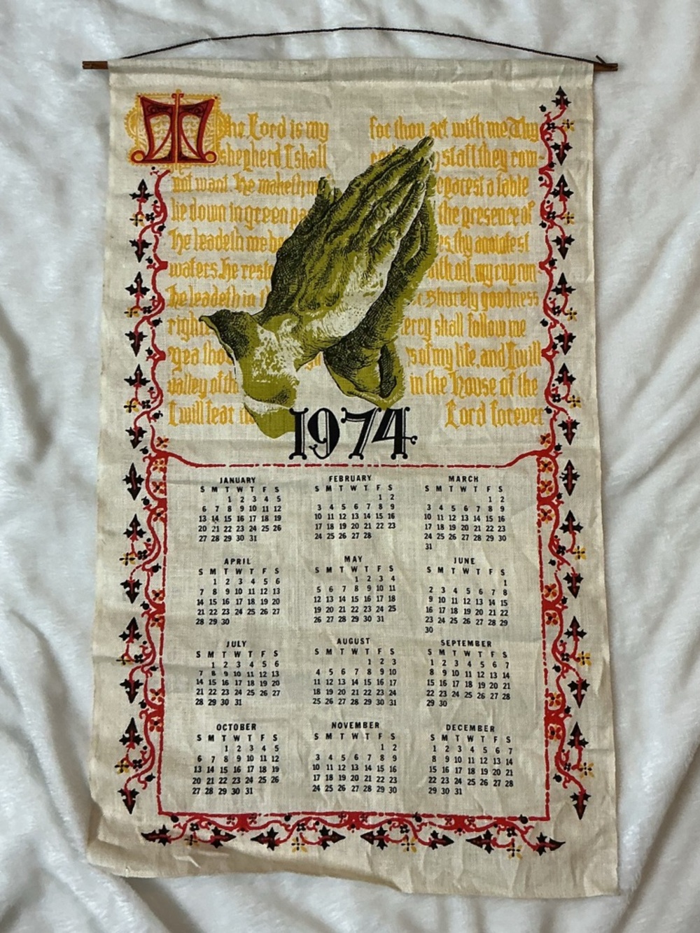 Vintage 1974 linen calendar tea towel featuring a religious praying hands